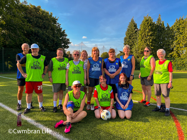 a female football team have a team photo after training