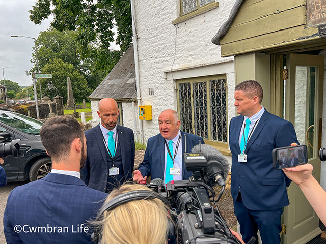 three councillors being interviewed by the media outside a pub