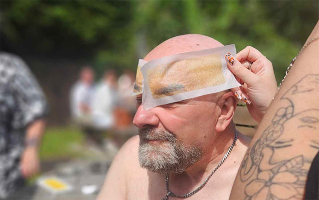 a man having his eyebrows waxed off