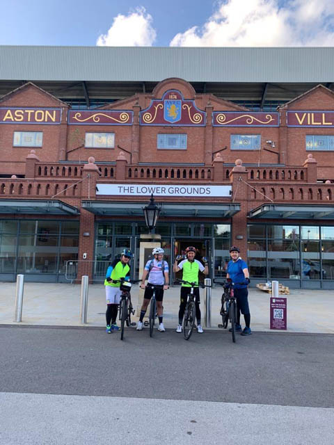 four men on bikes outside Aston Villa FC