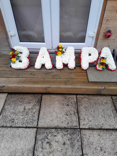 floral tributes spelling out Bampa