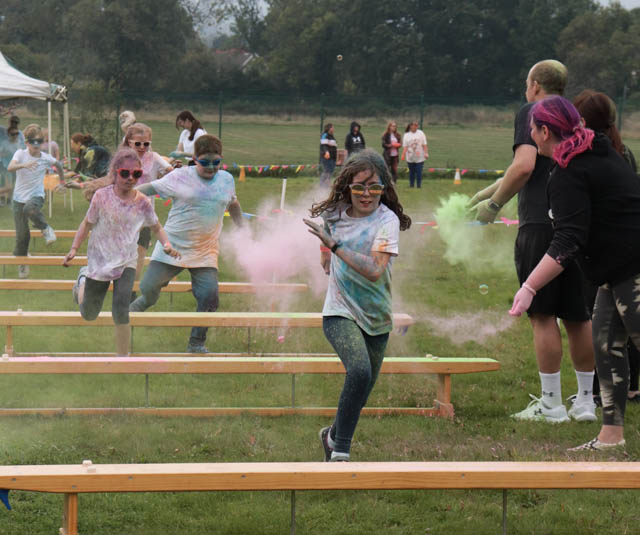 children run over benches on an obstacle course