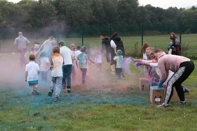 children run through powder paint