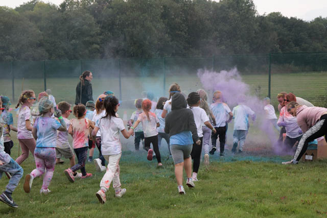 children run through powder paint