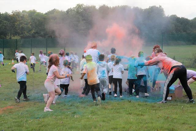 children run through powder paint