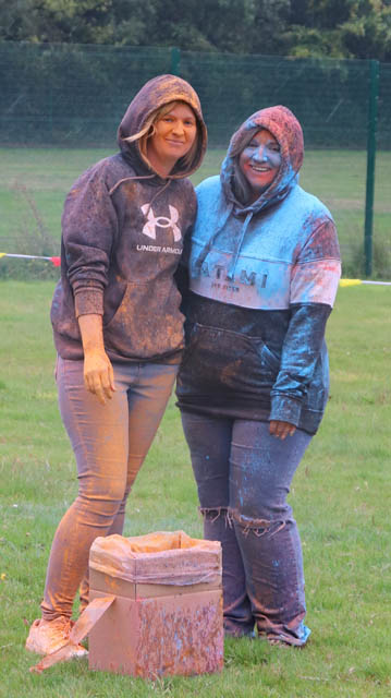 two women covered in powder paint