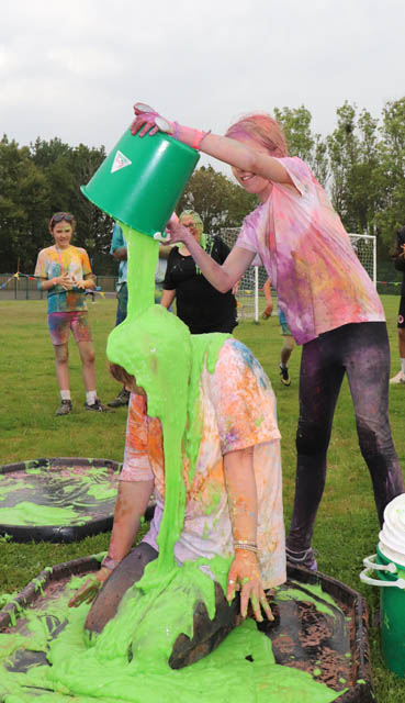 a girl pours green gunge over someone