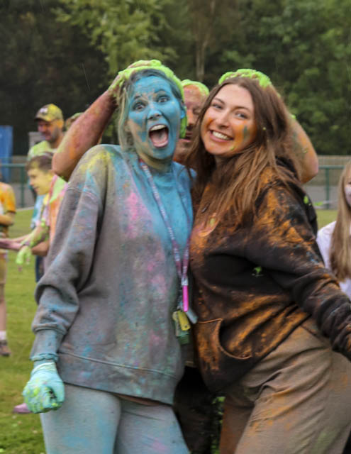 two women covered in powder paint