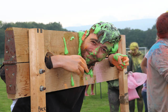 a man covered in gunge in stocks