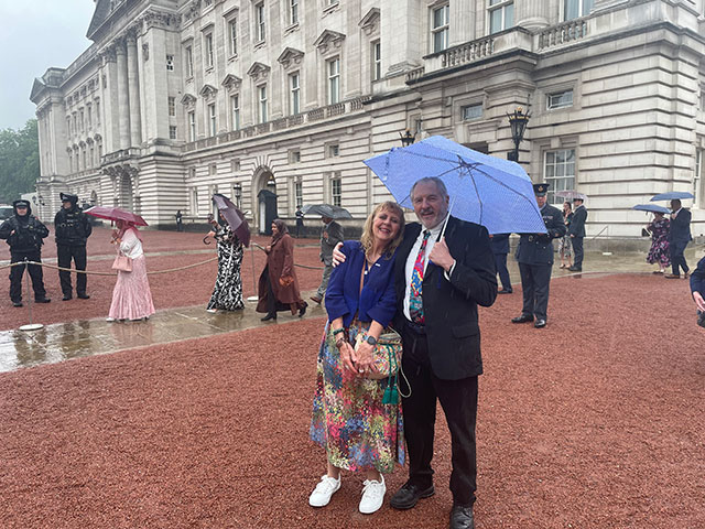 a man and woman outside Buckingham Palace