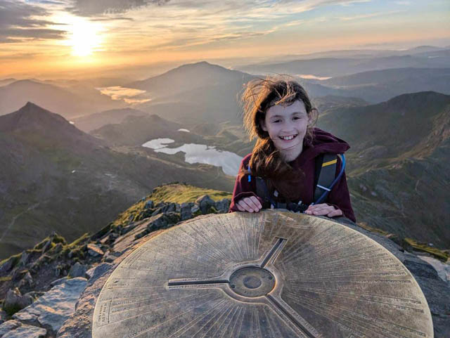 a ten-year old girl on top of mountain