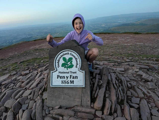 a ten-year old girl on top of mountain