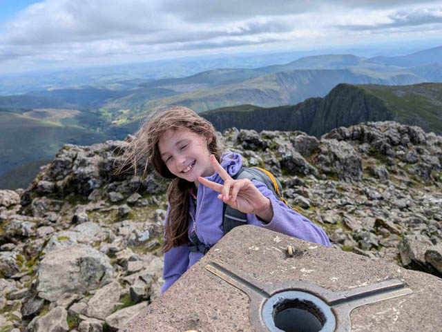 a ten-year old girl on top of mountain