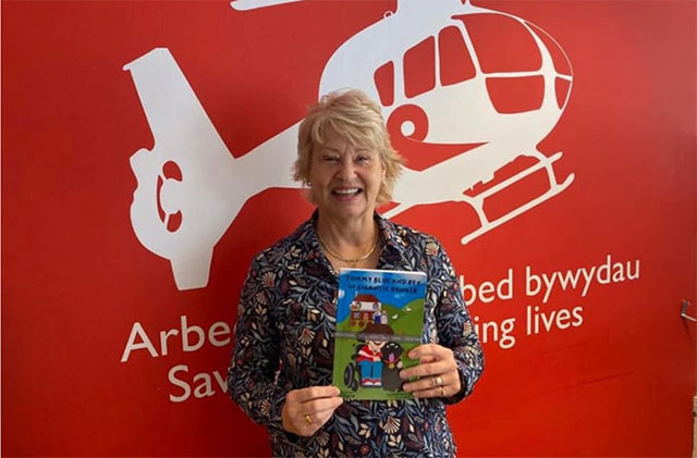 Jane Carter holding her new book that will raise money for Wales Air Ambulance