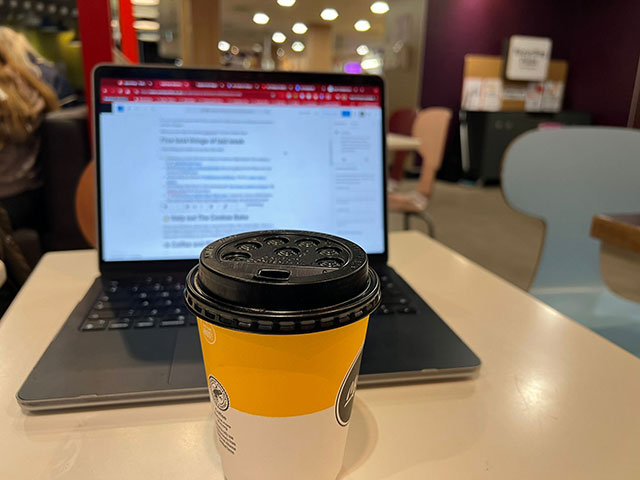 a coffee by a laptop