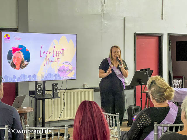 a woman gives a talk to a room of women