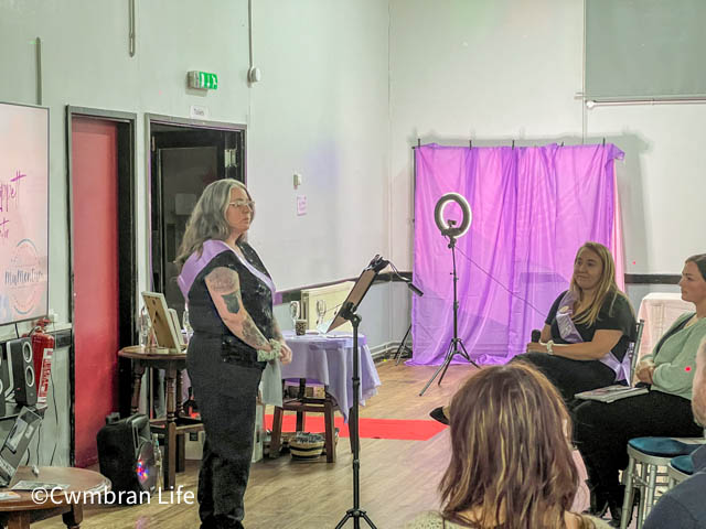 a woman gives a talk to a room of women