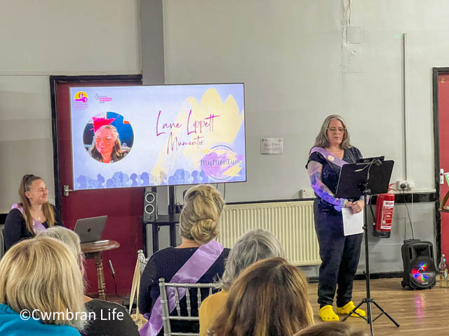 a woman gives a talk to a room of women