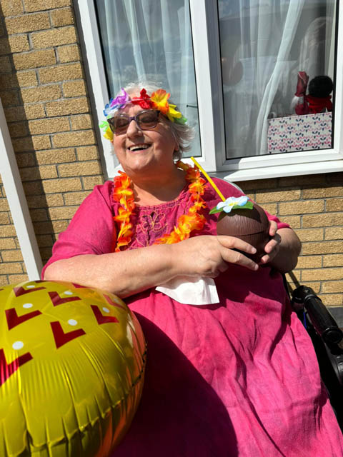 a woman with colourful flowers around her neck