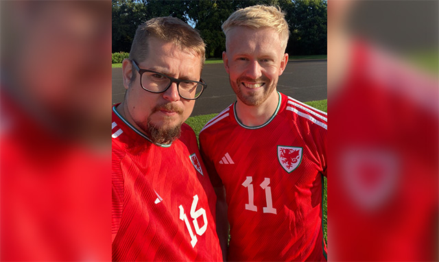 two men in red Wales football shirts