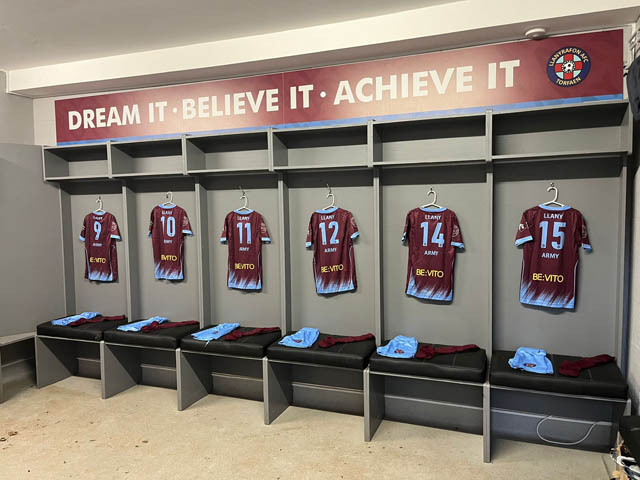 football shirts hanging in a changing room