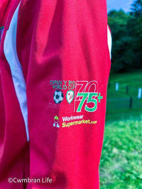 The badge on Mark's Wales tracksuit top with a badge for the over 70s and over 75s World Cup