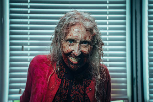 an actor with fake blood across her face