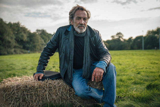 man sat on bale of hay