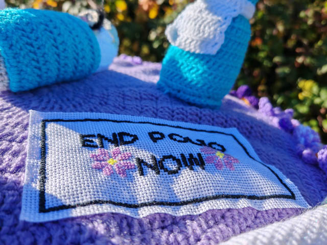 a knitted blanket with End Polio now on it