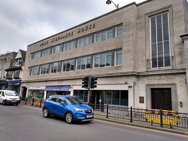 a large office building next to a road