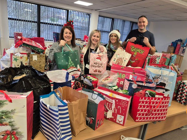 Torfaen Council's Young People's Support Service with some of the donated Christmas gifts