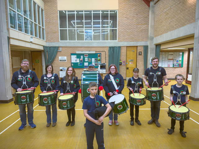 nine members of a pipe and drum band