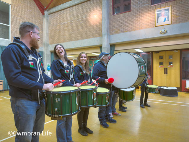 four drummers hold their instruments