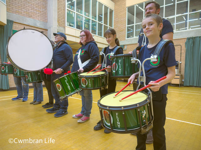 five drummers hold their instruments