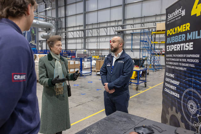 princess royal in a factory talking to staff