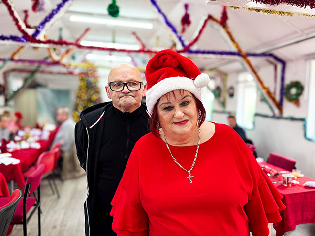 a woman in santa hat with a man