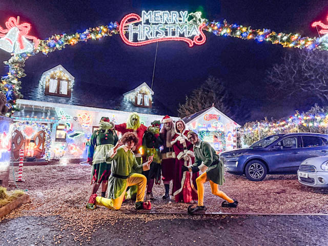 Father Christmas and Mrs Claus, elevs and the Grinch wait to greet people outside the former Henllys Village Hall