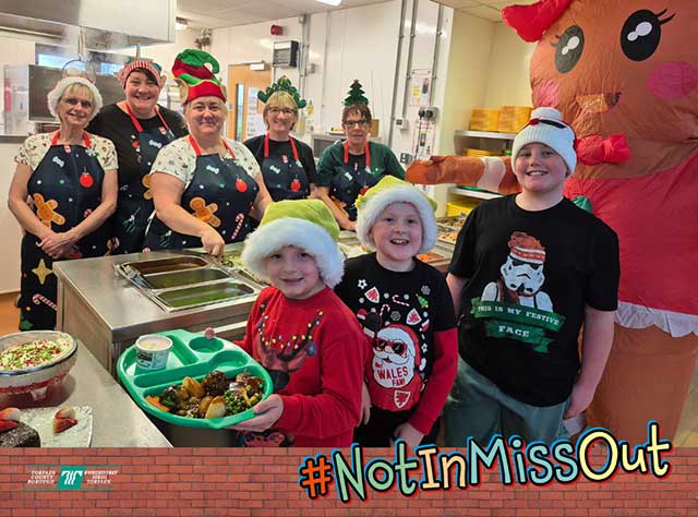 children and catering staff in a canteen