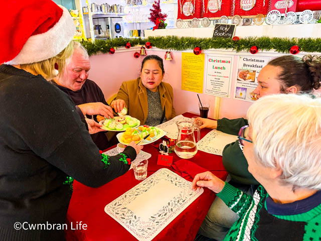 Lesley serves cakes to customers