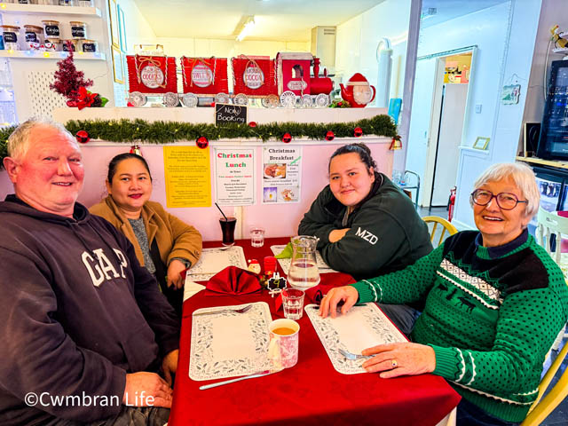 four people at a table in a cafe