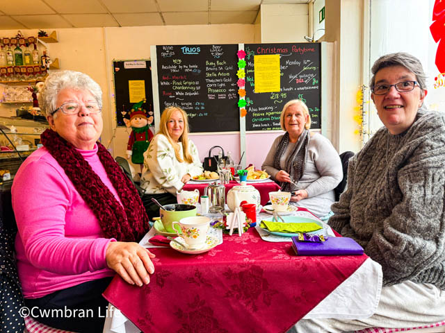 four people at a cafe table