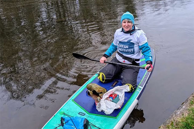 a woman kneeling on a paddleboard