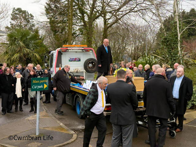 Mourners are the lorry as John Swain arrives at Gwent Crematorium