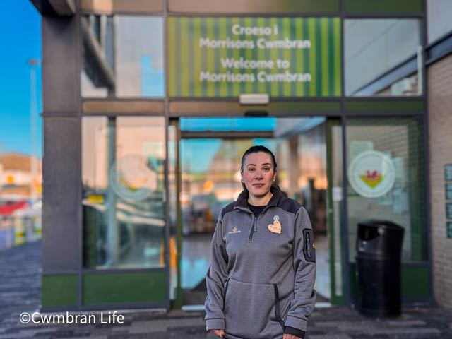 woman stood outside supermarket