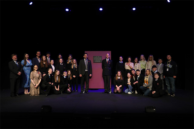 Prince Edward with large group of people on a stage