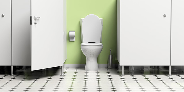 Water closet with open door and white toilet bowl.