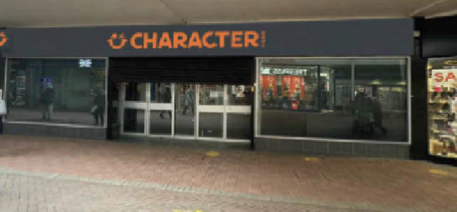 a shop with the sign Character above its entrance