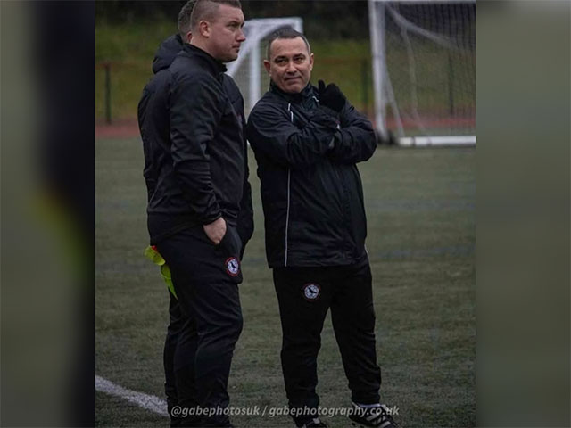 two men on side of football pitch