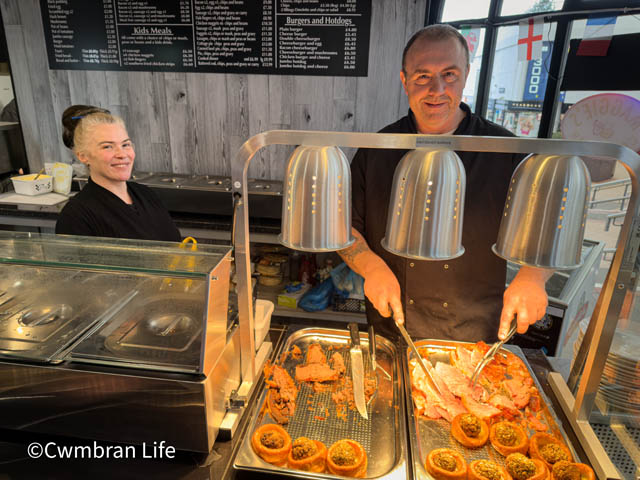 a man and woman serving carvery meat