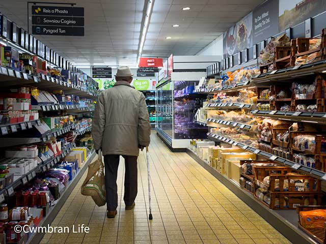 a man walking in a supermarket aisle